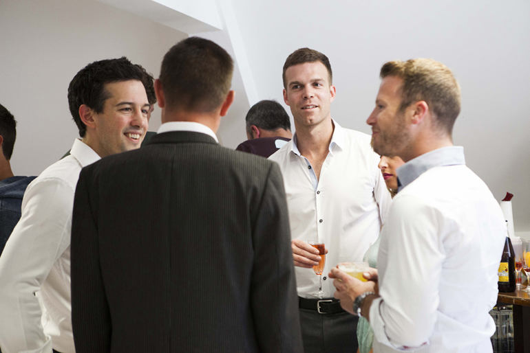 Group of four people talking at Socialising at the Indulge rebrand party